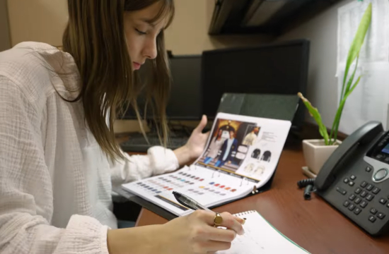  A picture capturing TAM student Cali Burns browsing through merchandise.