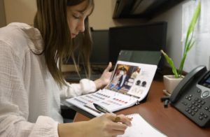 A picture capturing TAM student Cali Burns browsing through merchandise.