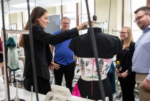 Textile and Apparel Management student displays their custom designed outfit during an open house